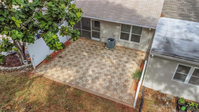 entry to storm shelter featuring a patio and central AC unit