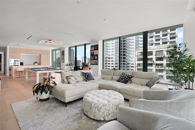 living room with hardwood / wood-style floors, billiards, and floor to ceiling windows