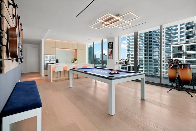 1000 Water St Unit 1002, Tampa, FL 33602 - recreation room with billiards, a wall of windows, and light hardwood / wood-style floors