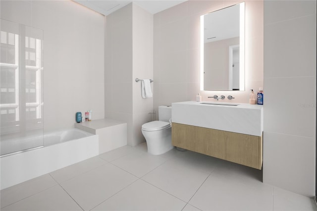 1000 Water St Unit 1002, Tampa, FL 33602 - bathroom with tile walls, vanity, tile patterned floors, and toilet