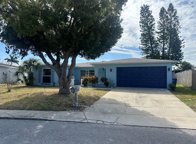 single story home with a garage and a front yard