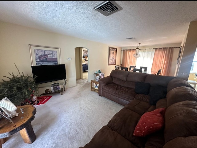 carpeted living room with a textured ceiling