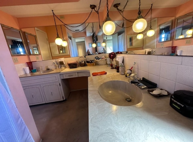 bathroom with tasteful backsplash and vanity