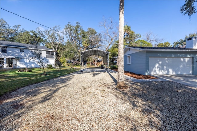 view of front facade with a garage, driveway, and a carport