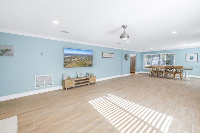 unfurnished room featuring light wood-type flooring, visible vents, and crown molding