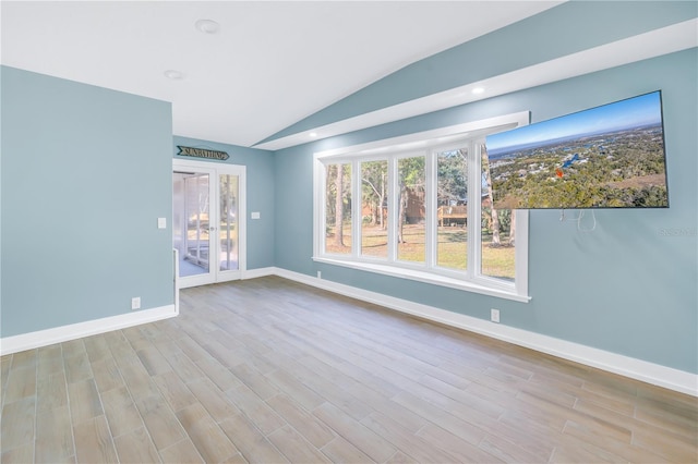 unfurnished room featuring lofted ceiling, baseboards, wood finished floors, and recessed lighting