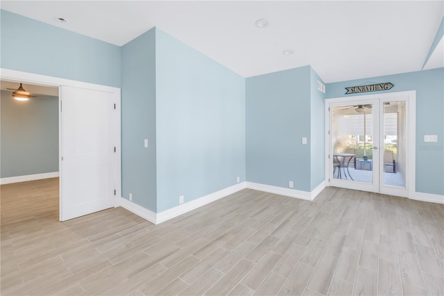 empty room with baseboards and light wood-style floors