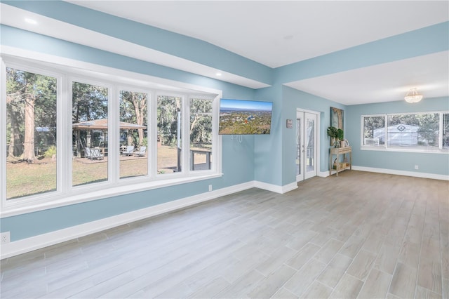 empty room with recessed lighting, baseboards, and wood finished floors