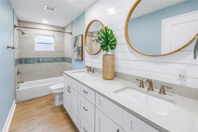 full bath with visible vents, a sink, toilet, and wood finished floors