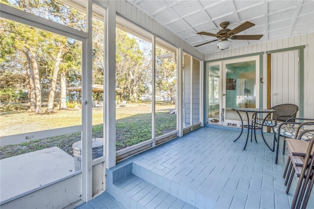 sunroom / solarium featuring a ceiling fan and plenty of natural light