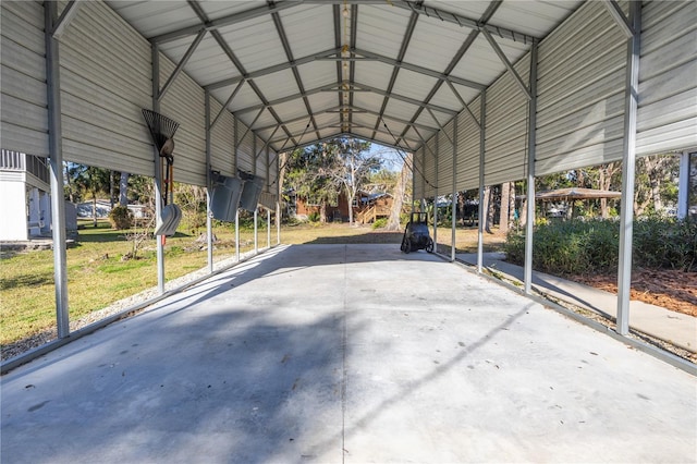 view of parking / parking lot featuring driveway and a detached carport