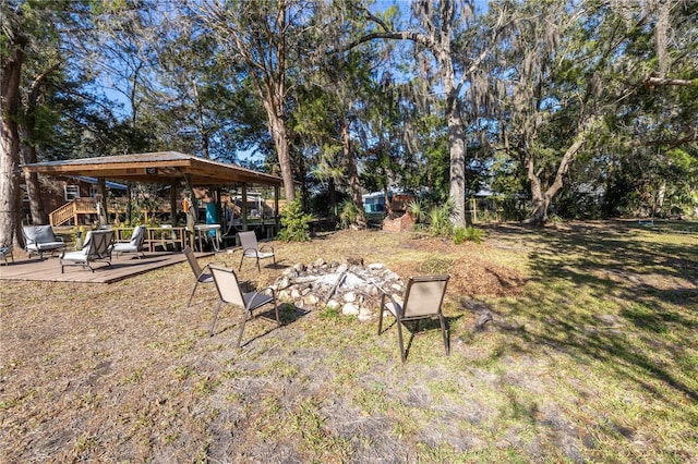 view of yard featuring a fire pit and a wooden deck