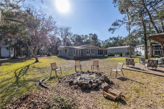 view of yard featuring a fire pit and a wooden deck