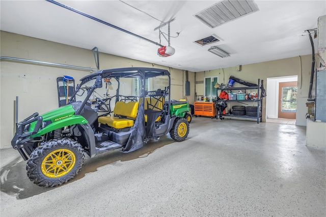 garage featuring a garage door opener and electric panel