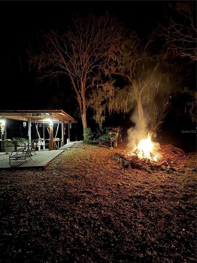 yard at twilight with a fire pit