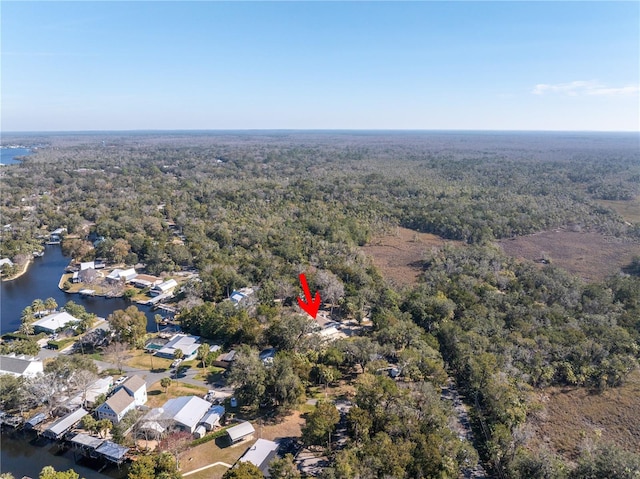 aerial view featuring a residential view, a water view, and a wooded view