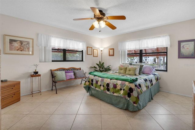 tiled bedroom featuring ceiling fan and baseboards