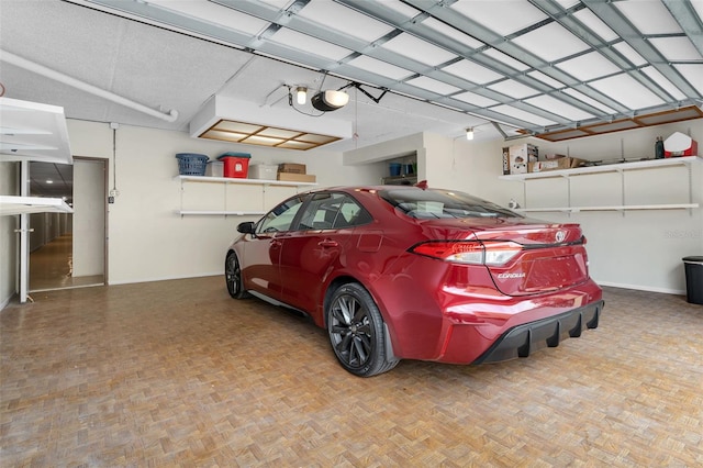 garage with baseboards and a garage door opener