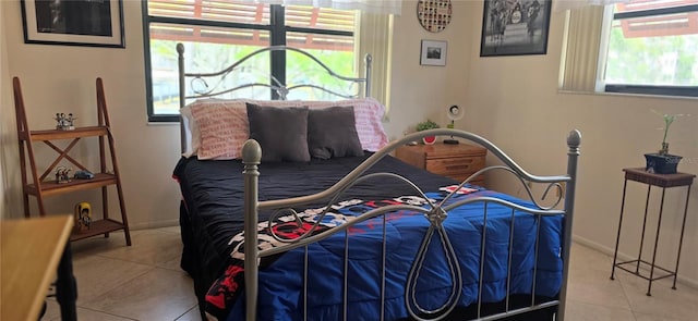 tiled bedroom featuring baseboards