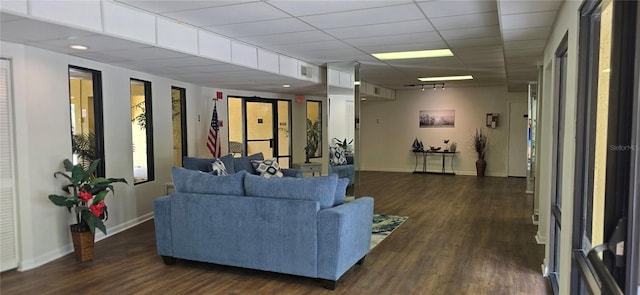 living room with dark wood-type flooring and baseboards