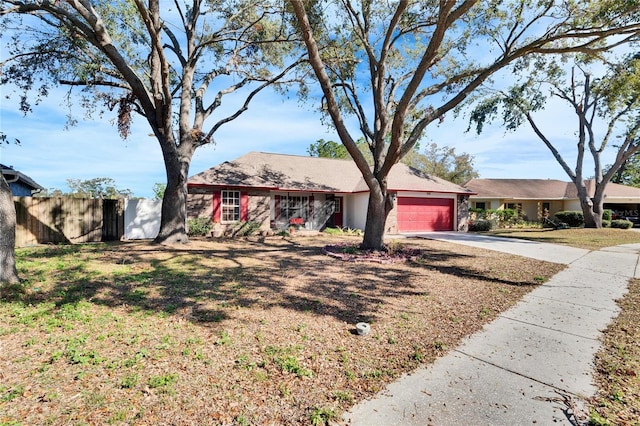 single story home featuring a garage and a front lawn