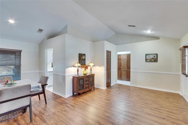 dining area with lofted ceiling and light hardwood / wood-style floors