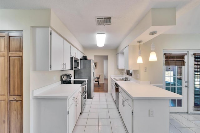 kitchen featuring pendant lighting, appliances with stainless steel finishes, light tile patterned floors, and white cabinets