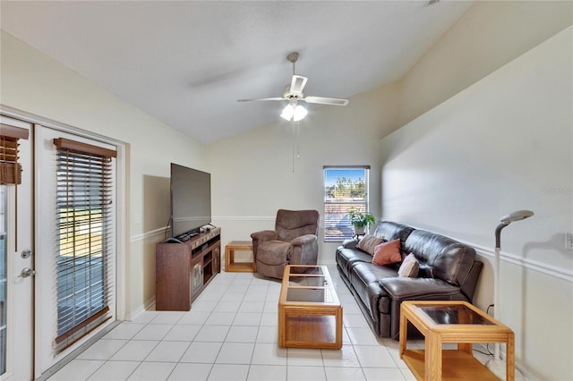 living room with lofted ceiling, light tile patterned floors, and ceiling fan