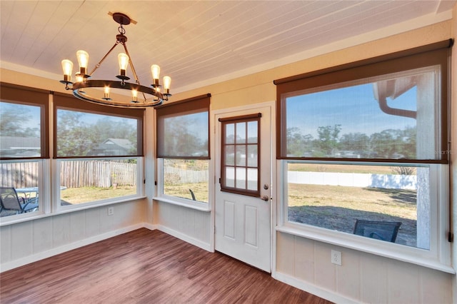 unfurnished sunroom featuring a notable chandelier