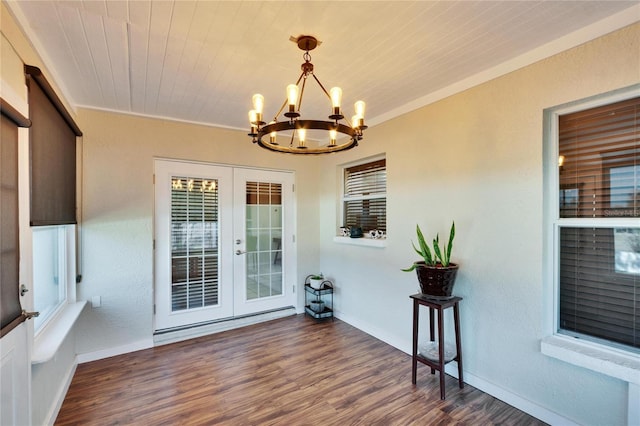 sunroom featuring a notable chandelier, wood ceiling, and french doors