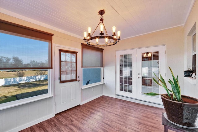 unfurnished sunroom with french doors, wood ceiling, and a chandelier