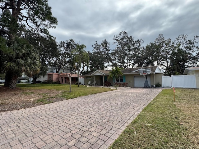 ranch-style house featuring a garage and a front yard