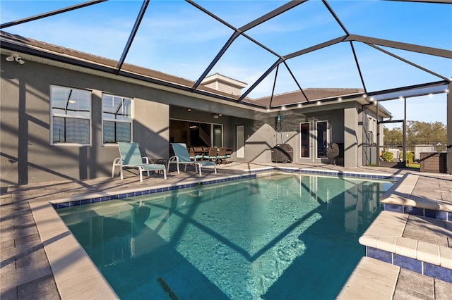 view of pool featuring a patio and glass enclosure