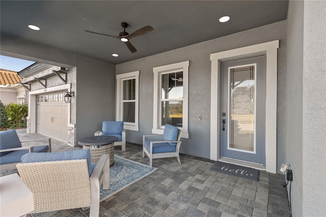 view of patio with ceiling fan and a garage