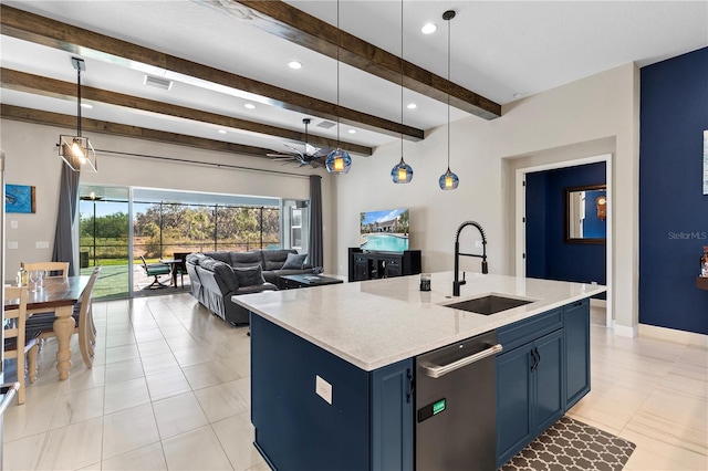 kitchen featuring blue cabinets, sink, a center island with sink, and decorative light fixtures