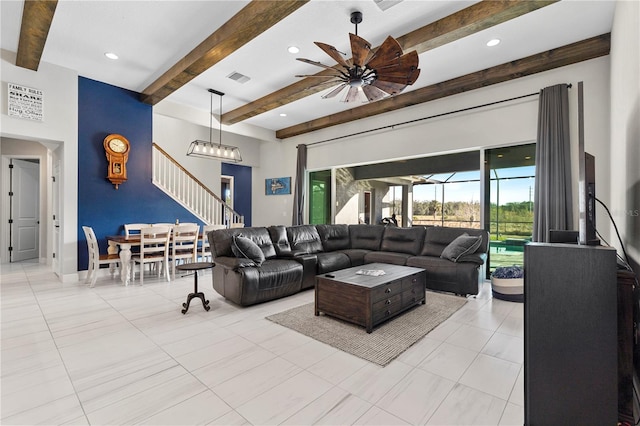 living room featuring beamed ceiling, light tile patterned floors, and ceiling fan