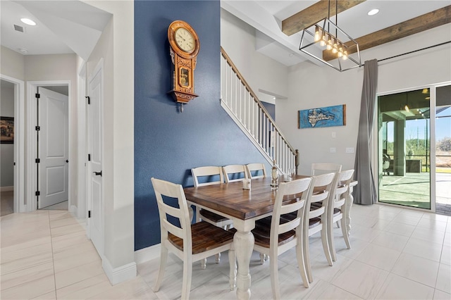 tiled dining room with an inviting chandelier and beam ceiling