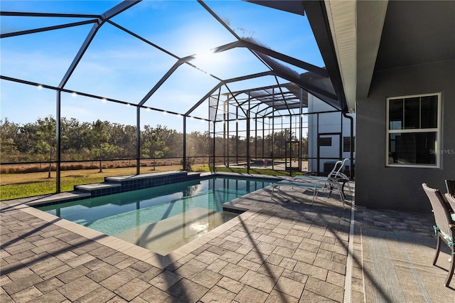 view of swimming pool featuring a patio and glass enclosure