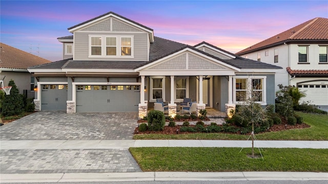 14215 Swiss Bridge Dr, Riverview, FL 33579 - view of front of home featuring a porch, an attached garage, decorative driveway, and a yard