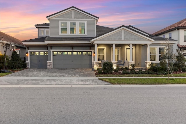 14215 Swiss Bridge Dr, Riverview, FL 33579 - view of front facade featuring an attached garage, a porch, decorative driveway, and stucco siding
