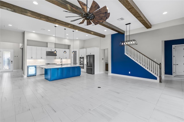 14215 Swiss Bridge Dr, Riverview, FL 33579 - kitchen featuring beamed ceiling, black fridge with ice dispenser, under cabinet range hood, open floor plan, and light countertops