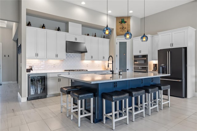 14215 Swiss Bridge Dr, Riverview, FL 33579 - kitchen featuring black fridge with ice dispenser, beverage cooler, under cabinet range hood, decorative backsplash, and white cabinetry