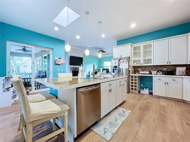 13653 Heritage Way, Sarasota, FL 34240 - kitchen with pendant lighting, stainless steel appliances, an island with sink, and white cabinets