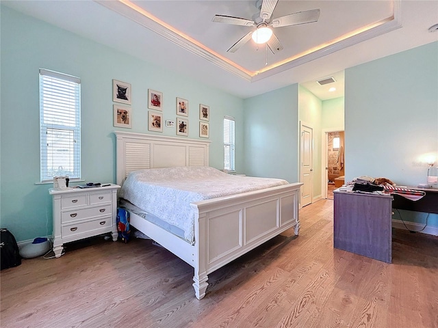 13653 Heritage Way, Sarasota, FL 34240 - bedroom featuring hardwood / wood-style flooring, ceiling fan, a raised ceiling, and multiple windows