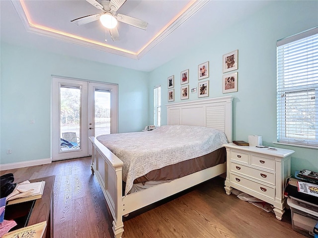 13653 Heritage Way, Sarasota, FL 34240 - bedroom with french doors, dark hardwood / wood-style floors, access to exterior, and a tray ceiling