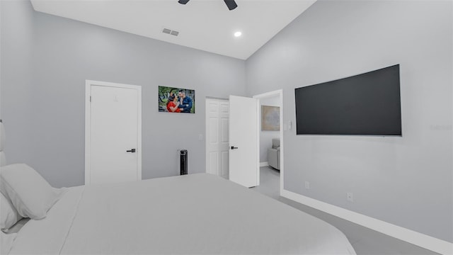 bedroom with ceiling fan and a towering ceiling