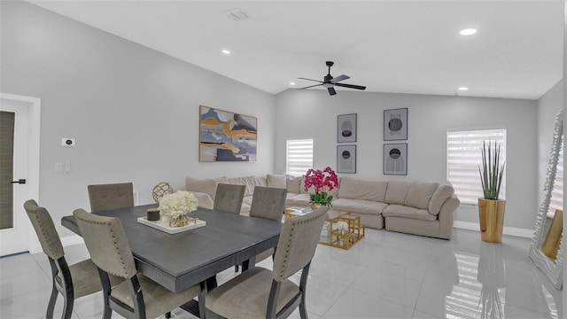 tiled dining space featuring lofted ceiling, a wealth of natural light, and ceiling fan