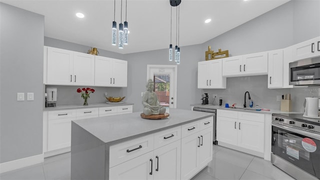 kitchen featuring pendant lighting, white cabinetry, stainless steel appliances, and sink