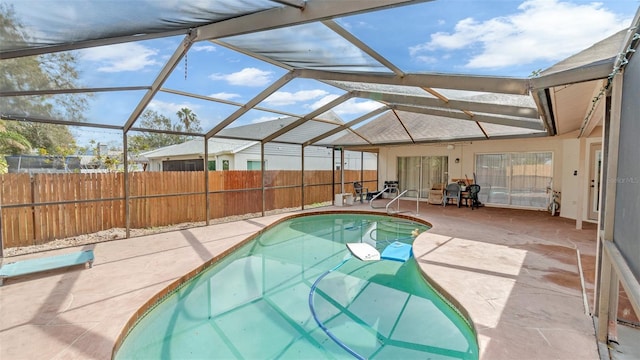 view of pool featuring a patio and glass enclosure