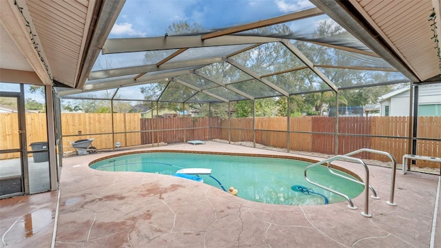 view of pool featuring a patio and glass enclosure